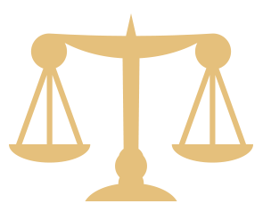 A gold colored symbol of the scales of justice.